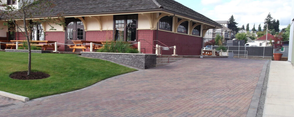 paving stone driveway and stone planters